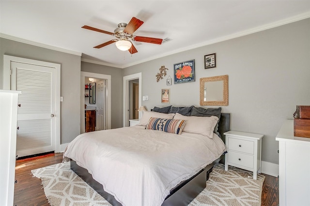 bedroom featuring ornamental molding, ceiling fan, baseboards, and wood finished floors