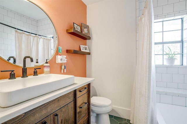 bathroom featuring toilet, tile patterned flooring, and vanity