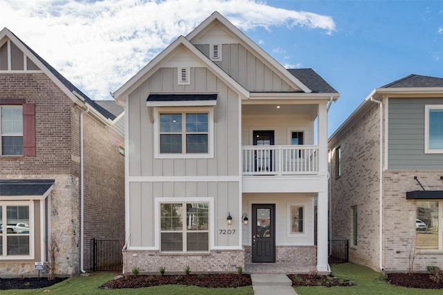 view of front of property with a balcony, a shingled roof, fence, and board and batten siding