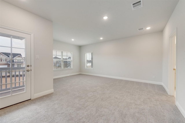 empty room featuring baseboards, carpet, visible vents, and recessed lighting