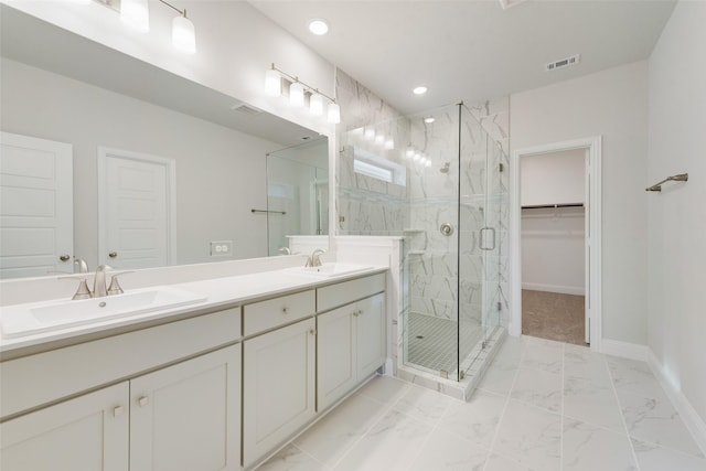 full bath with marble finish floor, a marble finish shower, visible vents, a sink, and baseboards