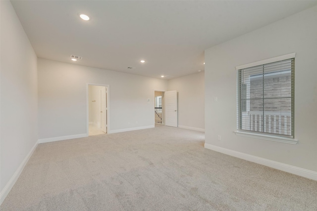 unfurnished room with recessed lighting, visible vents, baseboards, and light colored carpet