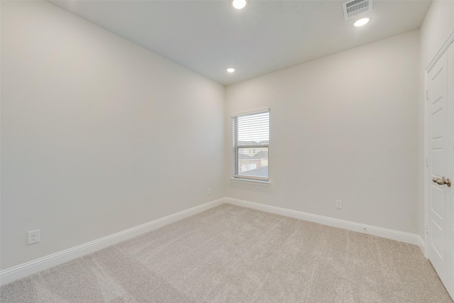 unfurnished room featuring baseboards, recessed lighting, visible vents, and light colored carpet