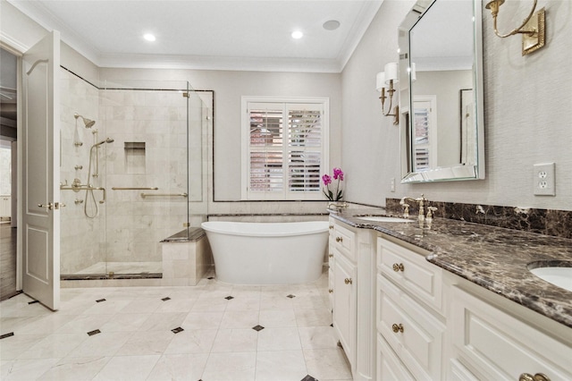 full bathroom featuring a stall shower, ornamental molding, a sink, and a soaking tub