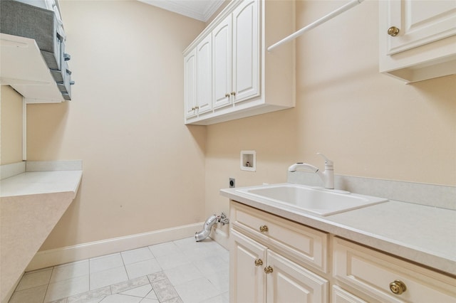 washroom featuring hookup for an electric dryer, washer hookup, a sink, baseboards, and cabinet space