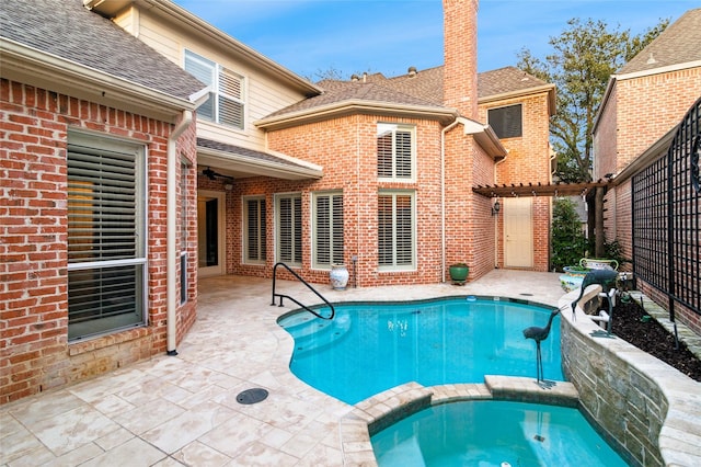 view of swimming pool with a pool with connected hot tub and a patio