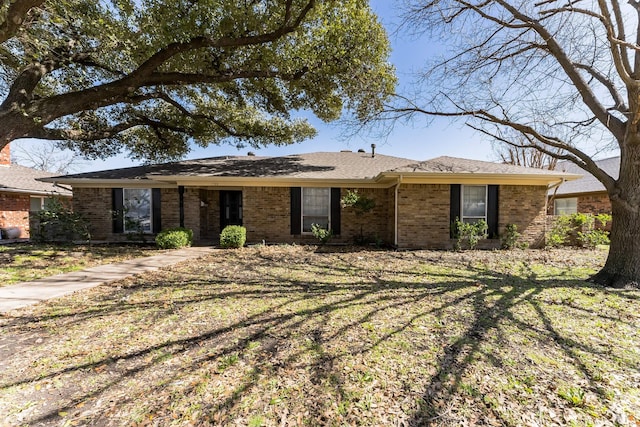 ranch-style home featuring brick siding