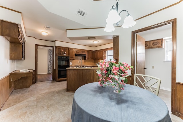 dining room with a healthy amount of sunlight, visible vents, and an inviting chandelier