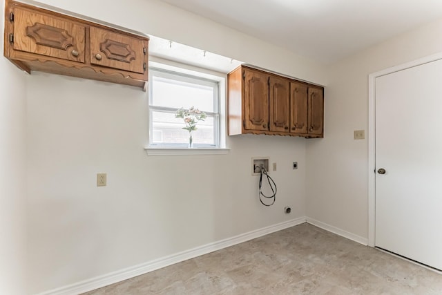 washroom featuring baseboards, washer hookup, cabinet space, and electric dryer hookup