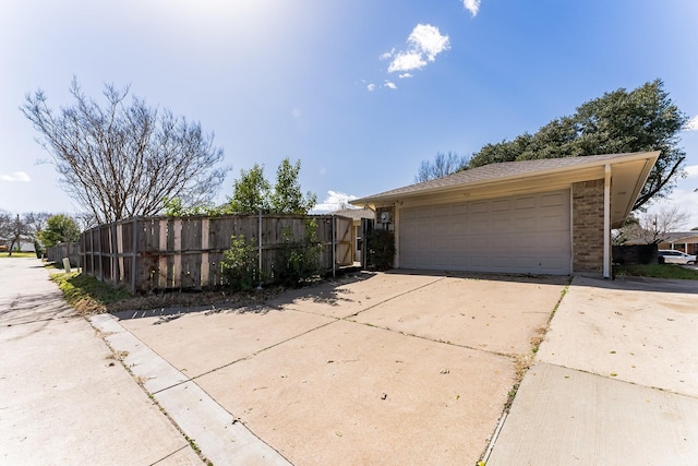 exterior space with a garage, fence, and an outdoor structure