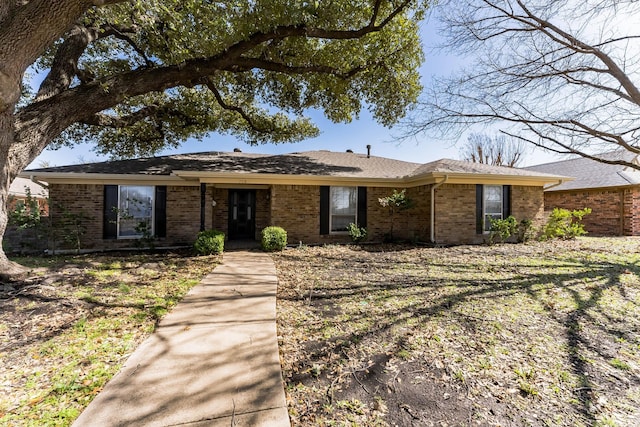 ranch-style house featuring brick siding