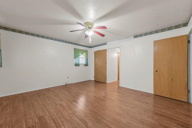 interior space featuring a ceiling fan and wood finished floors