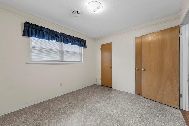 unfurnished bedroom featuring visible vents and baseboards