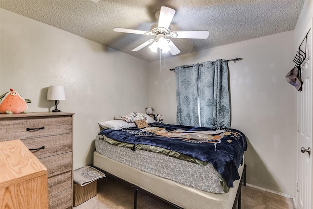 carpeted bedroom with ceiling fan and a textured ceiling