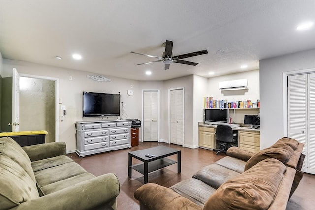 living room featuring recessed lighting, baseboards, built in desk, and a wall mounted air conditioner