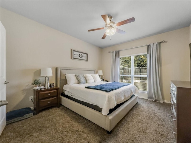 bedroom with a ceiling fan, carpet flooring, and baseboards