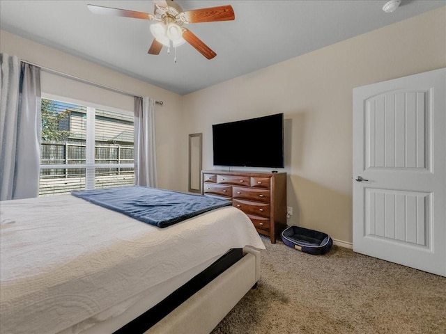 bedroom with baseboards, a ceiling fan, and carpet flooring