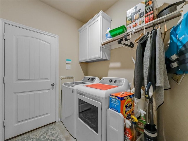 clothes washing area with cabinet space and washer and clothes dryer