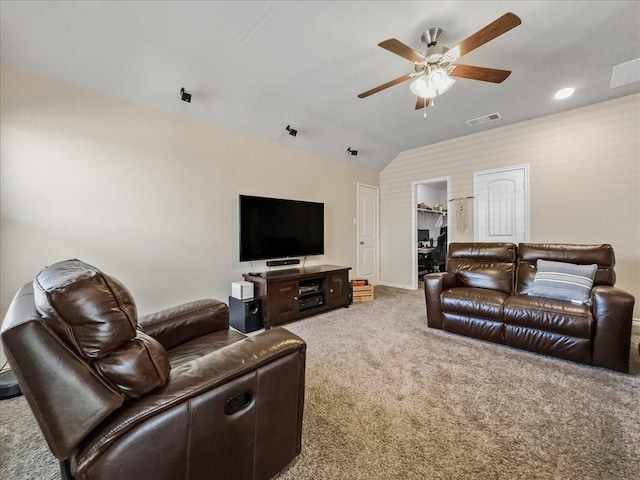 carpeted living area featuring baseboards, visible vents, vaulted ceiling, and a ceiling fan