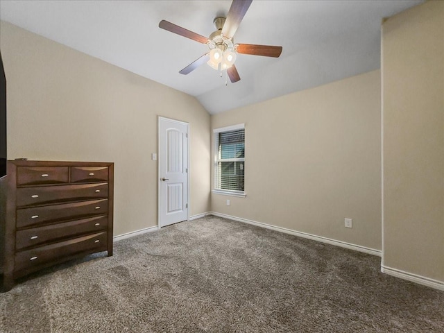 unfurnished bedroom featuring carpet floors, lofted ceiling, ceiling fan, and baseboards