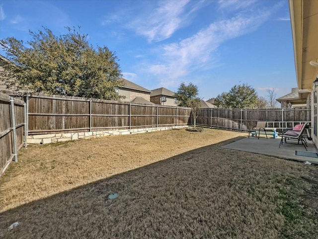 view of yard with a fenced backyard and a patio