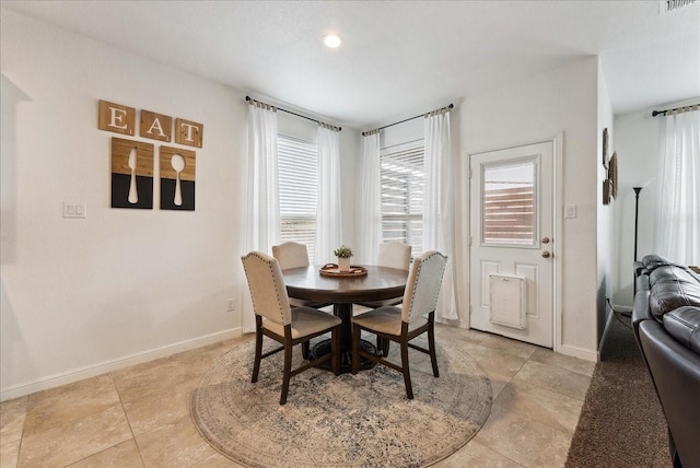 dining space featuring visible vents and baseboards