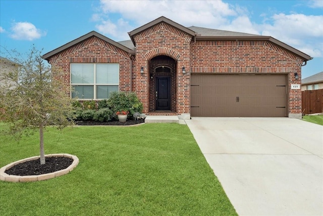 ranch-style house with a garage, driveway, a front lawn, and brick siding