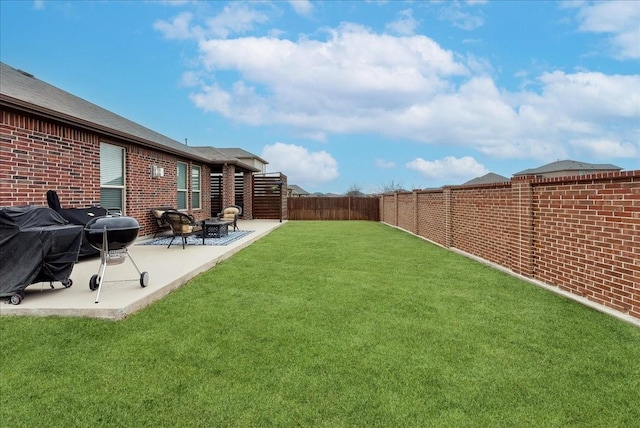 view of yard with a patio and a fenced backyard