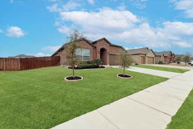 view of front of property featuring a garage, driveway, solar panels, fence, and brick siding