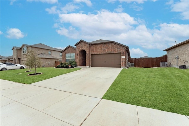 view of front of house featuring a garage, brick siding, fence, driveway, and a front yard