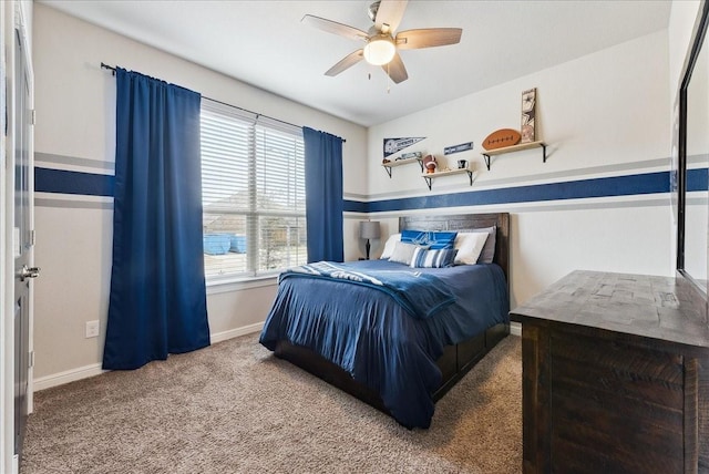 carpeted bedroom featuring baseboards and a ceiling fan