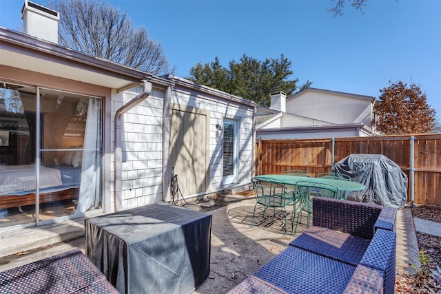 deck featuring outdoor dining area, a patio area, and fence