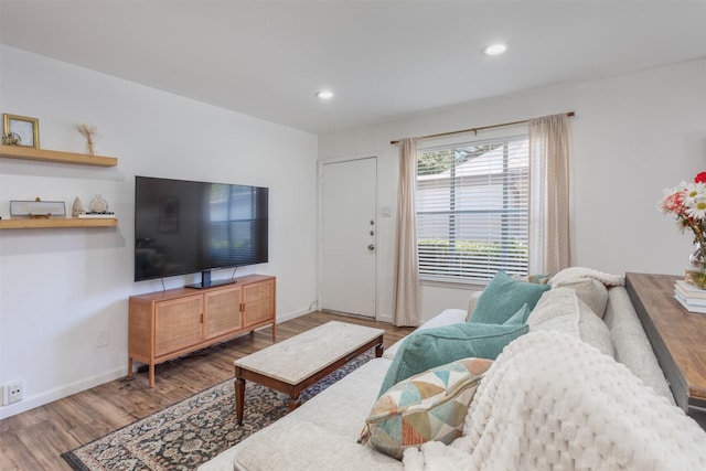 living room with recessed lighting, baseboards, and wood finished floors