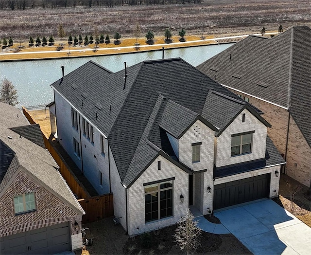 birds eye view of property with a water view