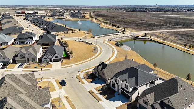 birds eye view of property with a water view and a residential view