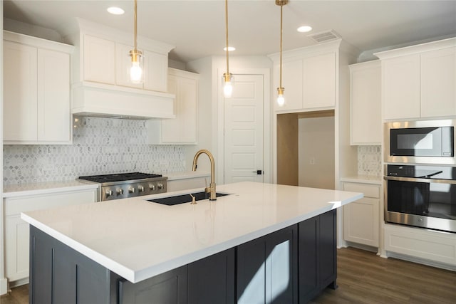 kitchen with tasteful backsplash, white cabinets, appliances with stainless steel finishes, custom exhaust hood, and a sink