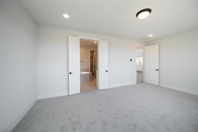 unfurnished bedroom with recessed lighting, carpet flooring, connected bathroom, and baseboards