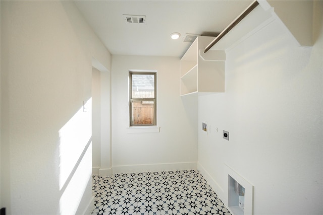 clothes washing area with laundry area, hookup for an electric dryer, visible vents, and baseboards