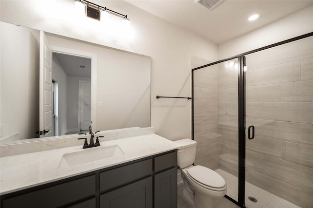 bathroom featuring a stall shower, visible vents, vanity, and toilet