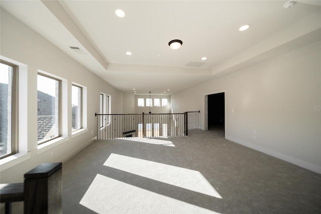 spare room with recessed lighting, carpet flooring, visible vents, and baseboards