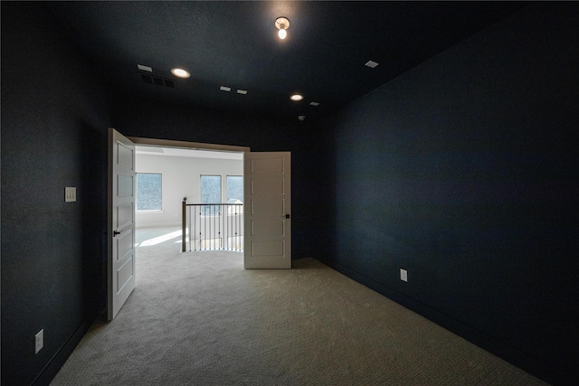 empty room with light carpet, baseboards, visible vents, and recessed lighting