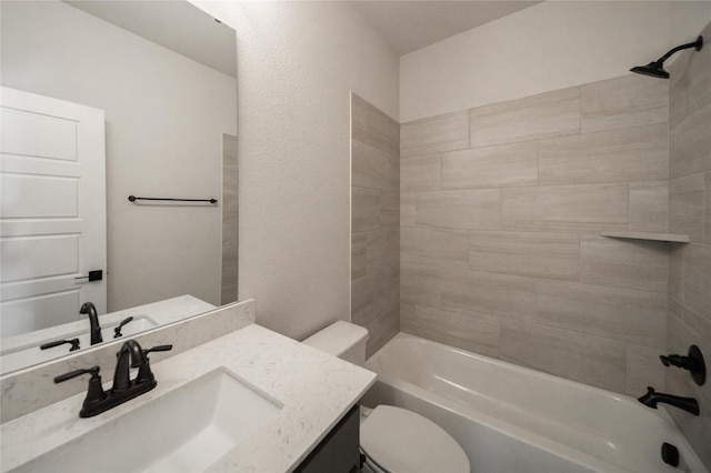 bathroom featuring  shower combination, vanity, and toilet