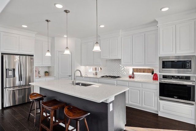 kitchen with a sink, dark wood-style floors, white cabinetry, and stainless steel appliances