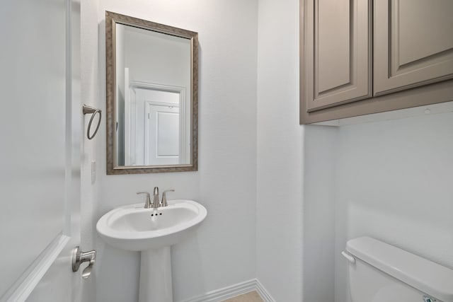 bathroom featuring toilet and a sink