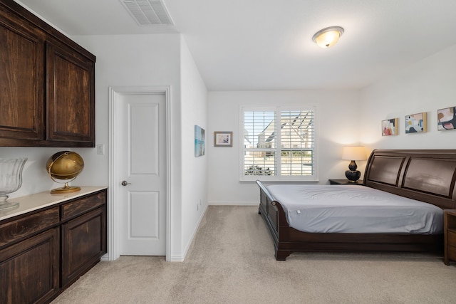 bedroom with visible vents, baseboards, and light colored carpet