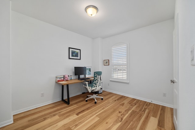 office area with light wood-style flooring and baseboards