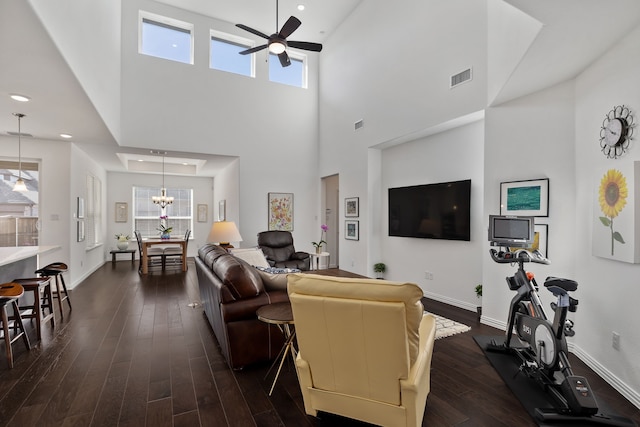 living room featuring visible vents, recessed lighting, baseboards, ceiling fan, and dark wood-style flooring