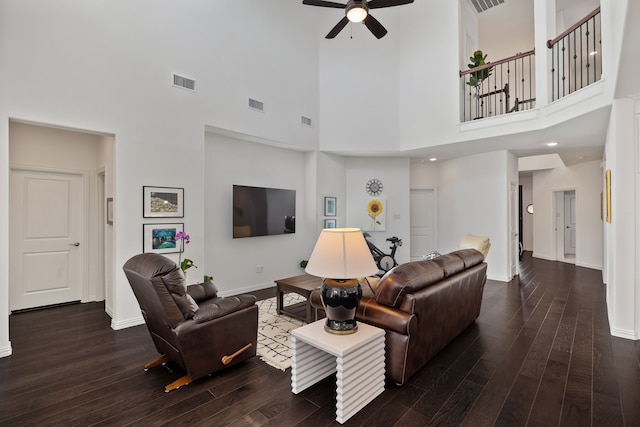 living area featuring wood finished floors, visible vents, and baseboards