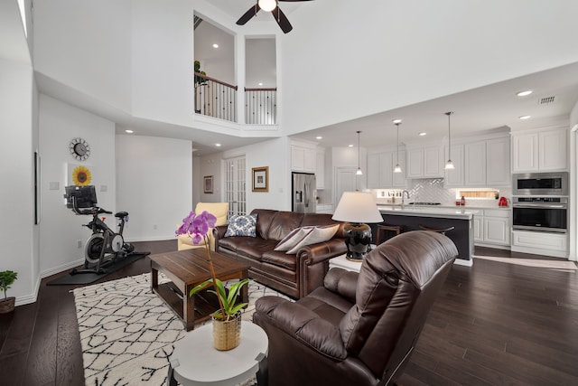 living area with visible vents, baseboards, recessed lighting, ceiling fan, and dark wood-type flooring