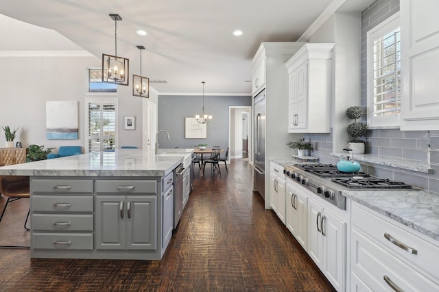 kitchen featuring stainless steel appliances, gray cabinets, white cabinetry, and a chandelier